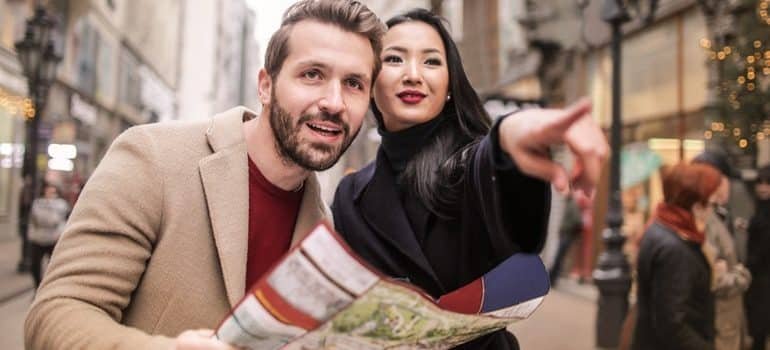 A person with a map getting help from a local