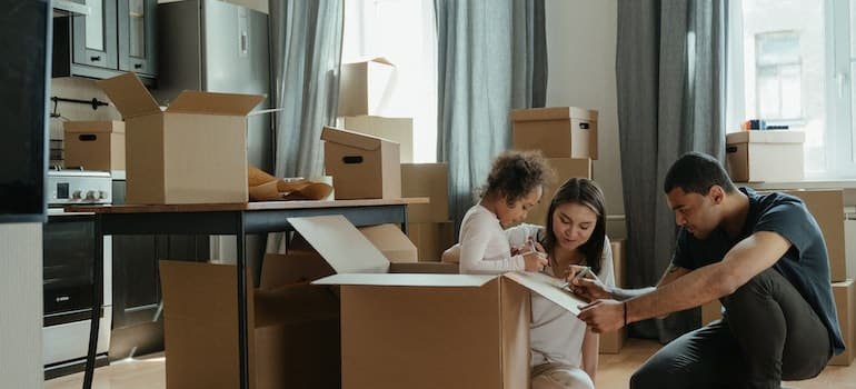 The family spends their first week after relocating to Dover by unpacking things in the kitchen;